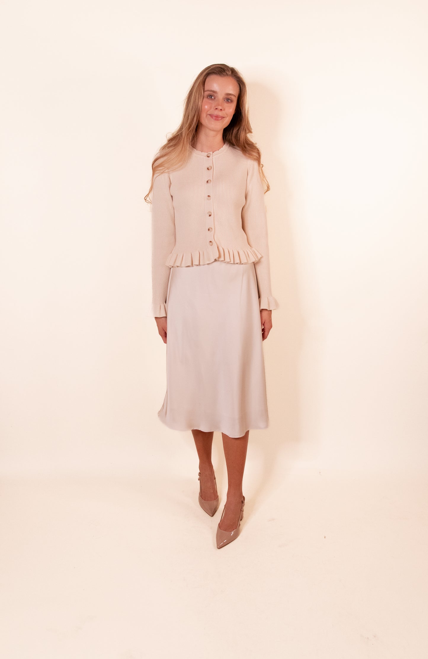 The Cora Ribbed Ruffle Cardigan in Cream