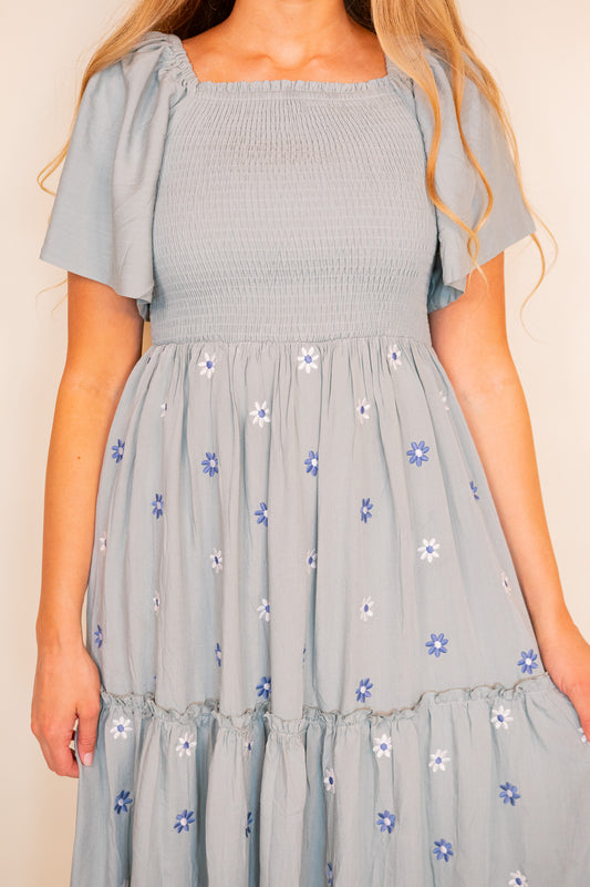 The Maya Smocked Embroidered Floral Dress in Dusty Blue