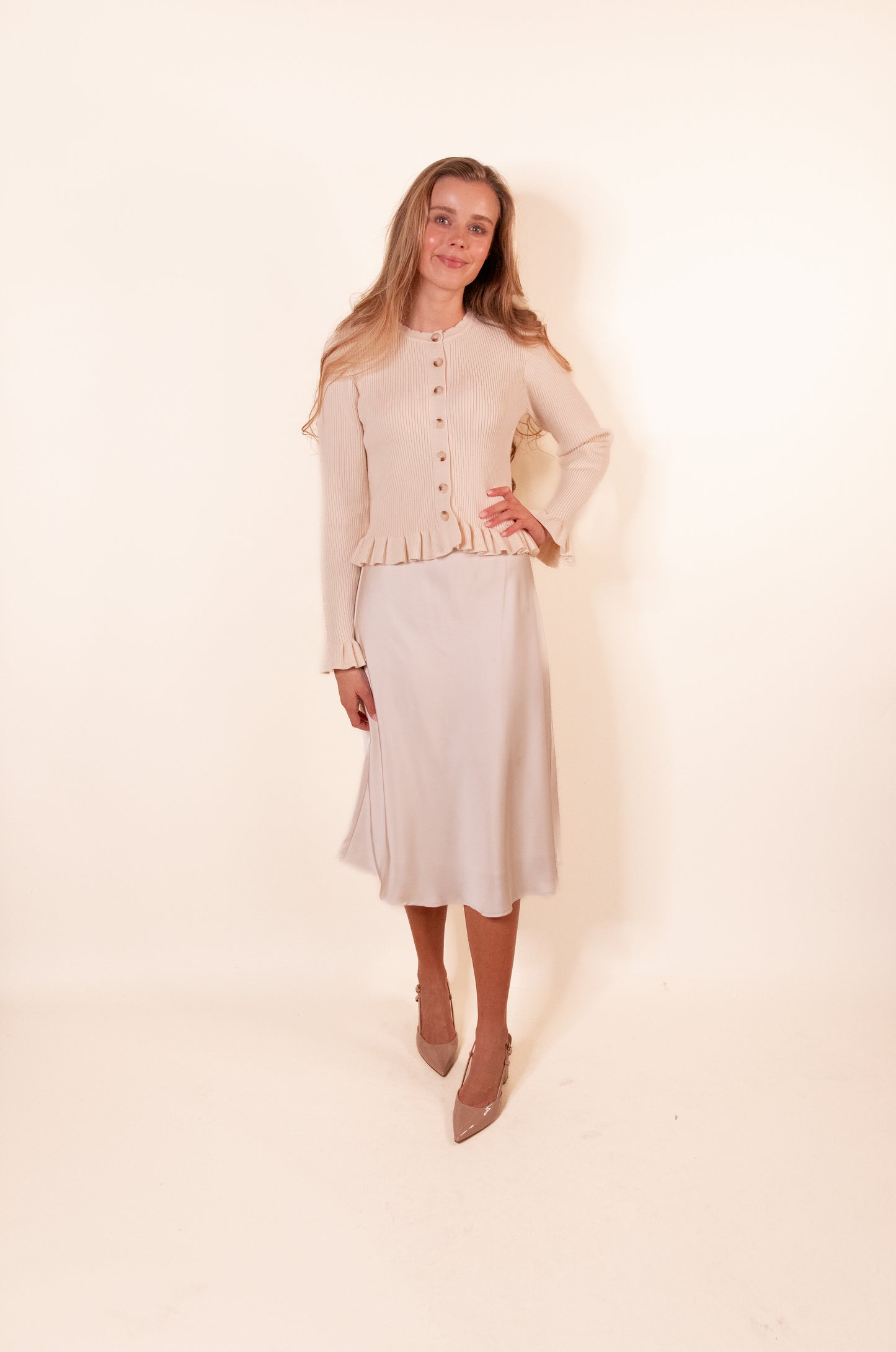 The Cora Ribbed Ruffle Cardigan in Cream