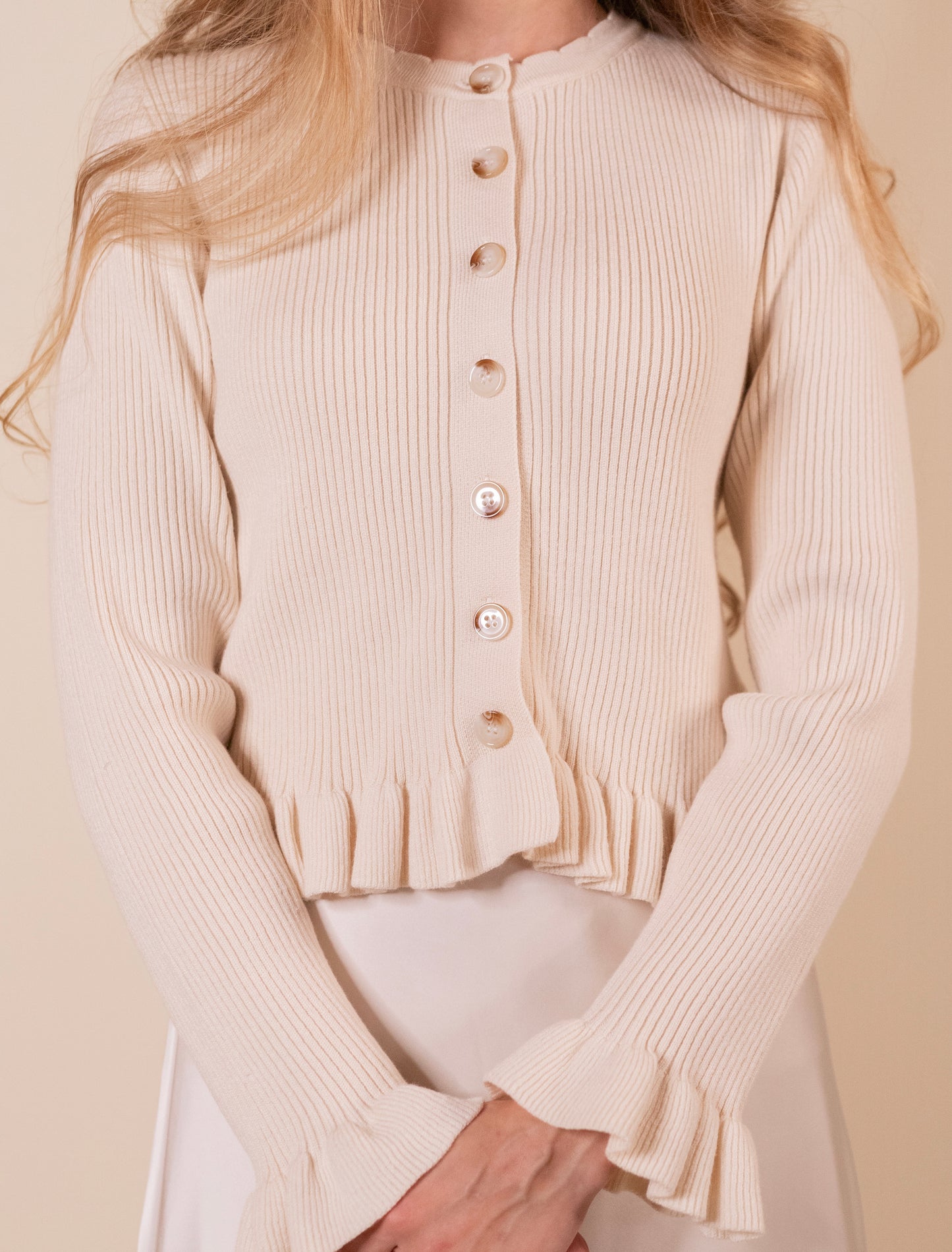 The Cora Ribbed Ruffle Cardigan in Cream