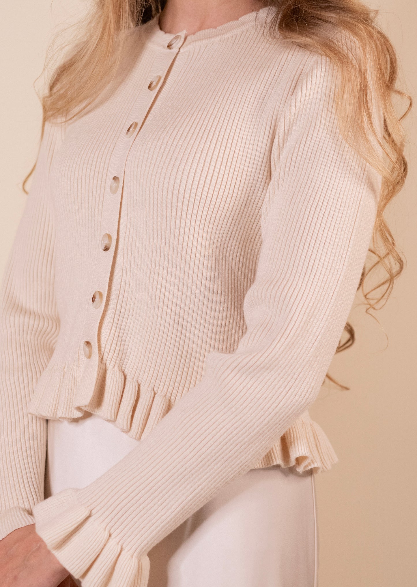 The Cora Ribbed Ruffle Cardigan in Cream